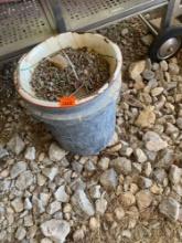 Metal bowel and 5 gallon bucket with nails