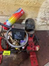 Small wire basket with Acetylene/oxygen tank cap, spray paint, Gas treatment, small battery and