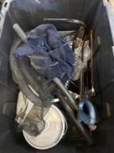 Tote with grout, handsaw, vacuum cleaner hoses