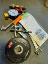 Pressure gauge, quick connect fitting for gas hose, grinding wheel, wrench, and other items