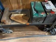 Two batteries, a wire brush, and a piece of iron