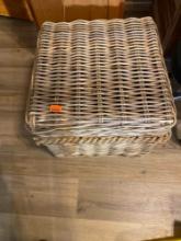 Wicker basket with hiking boots, hat and other items