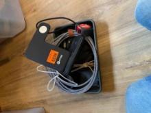 Small tape measure, small flashlight, hole saw and charging station