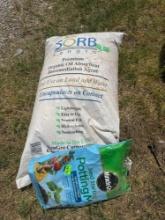 Bag of Organic oil absorbent agent and opened bag of potting soil