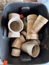 tub of mostly 4 in and 3 in fittings