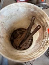 Bucket of pipe wrenches