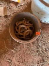 Feed bucket with horse shoes