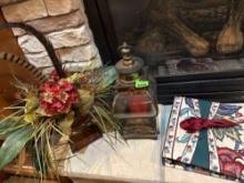Binder, candle lantern, floral and feather arrangement