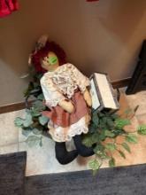 doll, fake plant and box