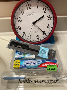 Clock, conair comb, scalp massager, pencil box, toothpaste and soap