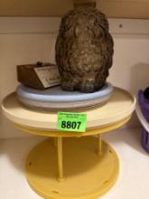 A glass owl, a sign, and a holder