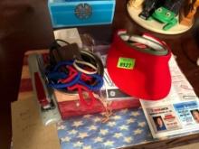 two ball caps, casino, card holders, alarms, stapler, and notepads