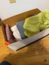 Box with towels, bedding items and other items