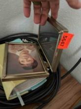 Hair clippers, photo frame, Bible and coax cable