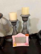 Candle holders with candles and a picture frame