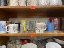 Items on middle shelf - glasses and coffee mugs