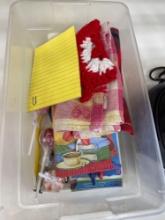 Small container with pens,dish towels and other misc items
