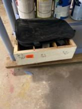 Homemade box with nails and a black bag