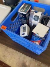 Blue milk crate with blood pressure monitor, hot/cold pack and mini heating pad