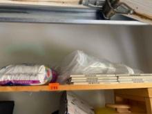 Items on shelf contains wood, grout, Clear zipper bag