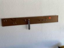 Strip of peg board with hooks