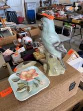 Parrot figurine and flowered plate