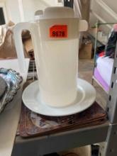Place mats, white plate, water pitcher
