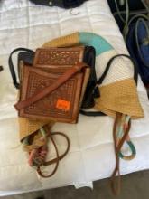 2 leather purses and one woven bag