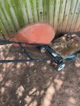 Part of a wheel barrel and part of a lawn mower