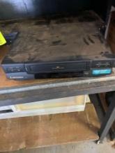 VHS player and weight and wall decor