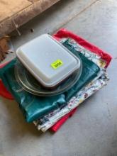 Table cloths, pie pan and tupperware ice cream container