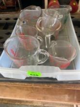 Several pyrex measuring cups