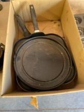 Box of skillets and a metal plate