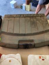 Action packer case with barbecue grill items and a vintage cutting board with mushroom pattern