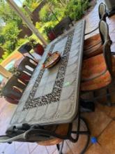 Outdoor metal table and set of 6 chairs with cushions. Item on table not included, bring help to