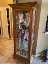 Curio cabinet with glass shelves and mirror backing. Contents inside and on top are not included.