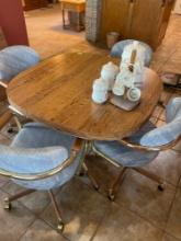 Dining room table with 4 rolling chairs and leaf. Bring help to load