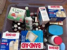 Plastic container, Band-Aids, callous remover, liquid nail polish, and Moore