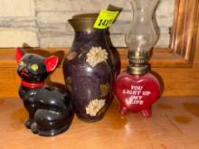 Cat, metal vase, oil lamp