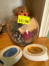 Glass bowl with popery, across, stuffed bear
