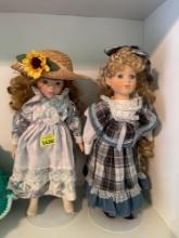 Three dolls, two porcelain and one vinyl