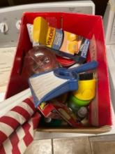 Box of misc items, hummingbird feeder, American flag, Velcro hanging strips, gorilla glue, raid bug