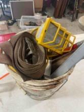Ratchet strap, halogen light, filter, and misc items in 5 gallon bucket