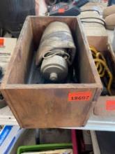 Magnifying glass, staplers, putty knife, water bottle in wooden box