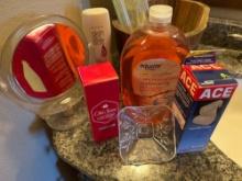 Wood decorative barrel, mirror, old spice, ace bandage wraps, glass lid, liquid soap, and a