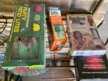 Hummingbird feeder, furniture feet, patio lights, ant bait, and solar panel on shelf on back porch