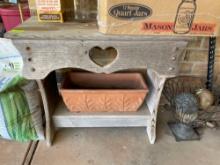 Wooden table and planter, items on top not included. On back porch