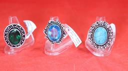 Three German silver rings. One size 6 Blue Topaz stone, one size 7 green emerald stone and one size