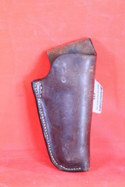 Brown leather right handed holster for small revolver. Used.