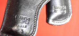 Two black tooled Bianchi leather right handed holsters. Used.